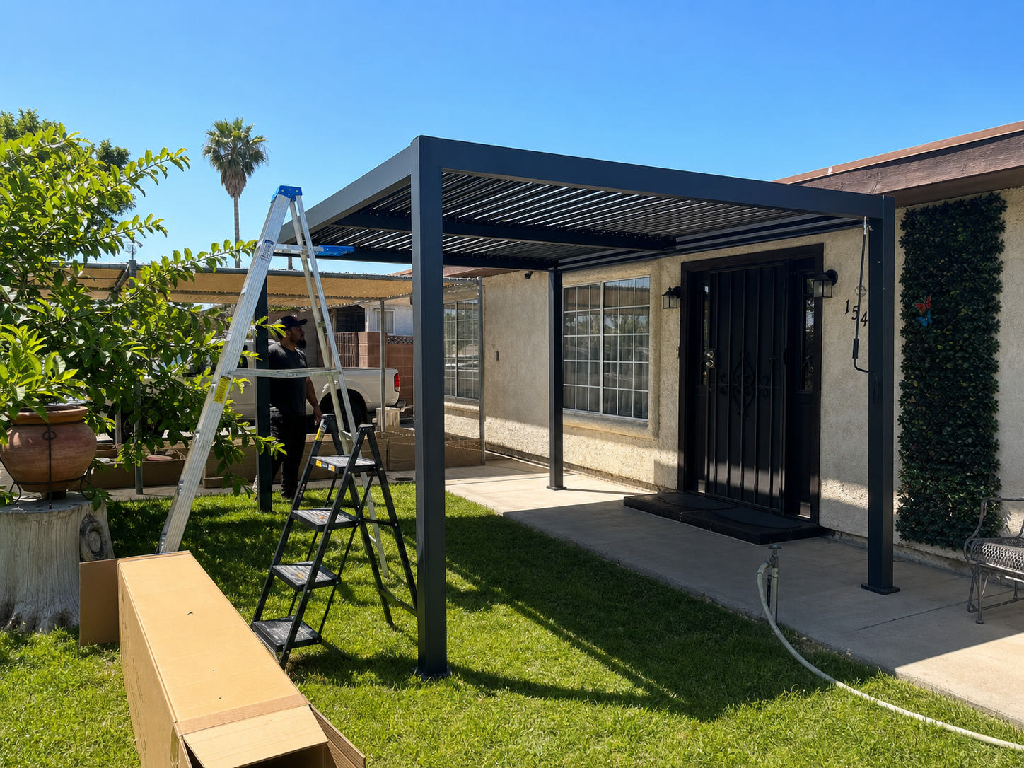 Installed PalmaYard pergola beside a modern patio